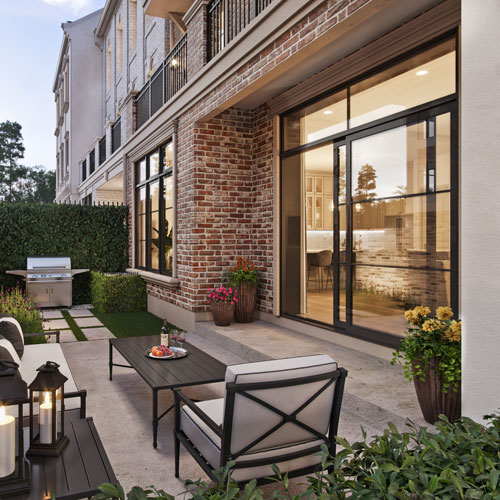 Private garden patio with seating outside a Wellington townhome